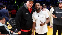 Irv Bauman (L) and Floyd Mayweather Jr. attend a playoff basketball game between the Los Angeles Lakers and the Golden State Warriors.