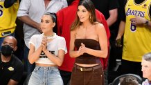 Kim Kardashian (L) and Sarah Staudinger attend a playoff baseketball game.