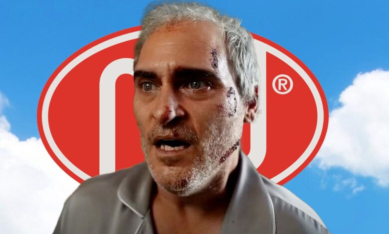 Joaquin Phoenix from Beau is Afraid in Front of Perfectly Safe Logo