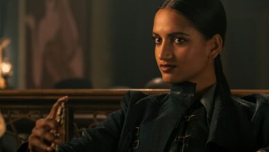 Inej Ghafa sitting down and smirking in Shadow and Bone.