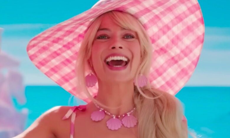 Margot Robbie as Barbie waving
