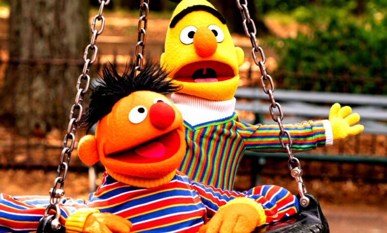 Sesame Street's Bert and Ernie riding in tire swing together