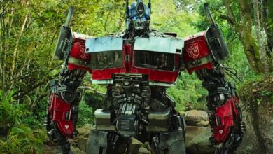 Optimus Prime standing in the forest in Transformers Rise of the Beasts