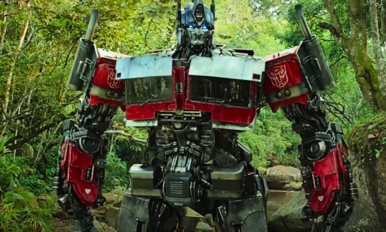 Optimus Prime standing in the forest in Transformers Rise of the Beasts