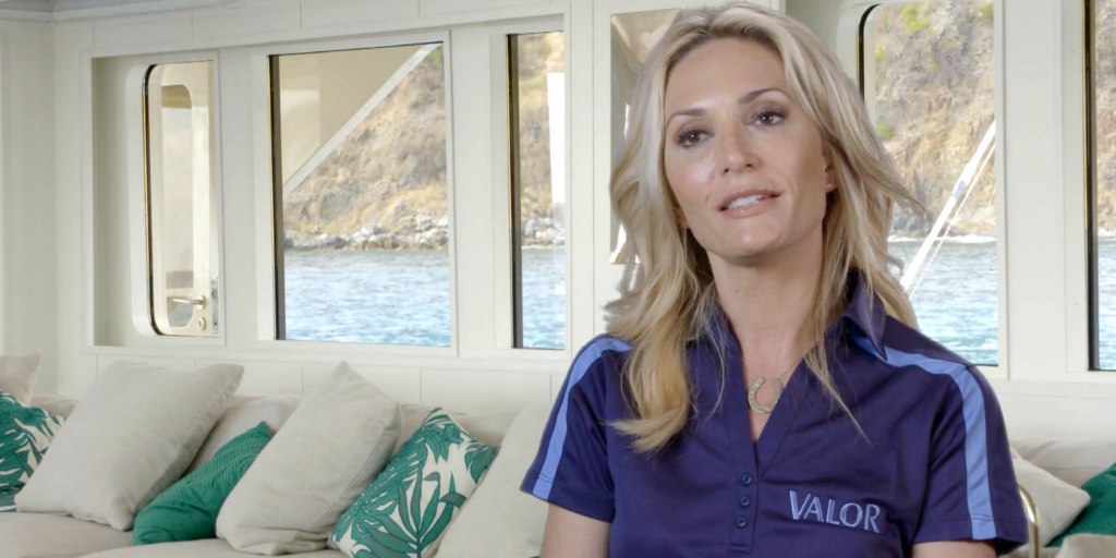 Below Deck's Kate Chastain on white boat in blue shirt