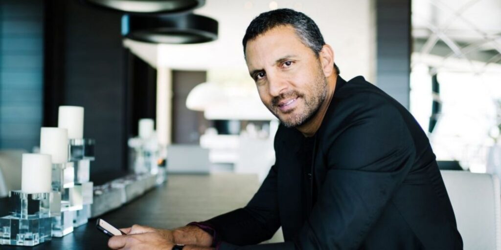 Mauricio Umansky sitting at a table for The Agency on RHOBH