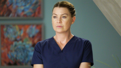 Meredith Grey in Grey's Anatomy standing in hallway wearing scrubs