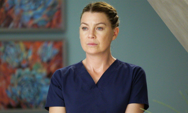Meredith Grey in Grey's Anatomy standing in hallway wearing scrubs