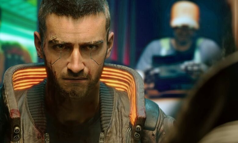 Cyberpunk 2077's male V scowling at a character off-screen. Stills from the three lifepaths are blurred in the background behind him.