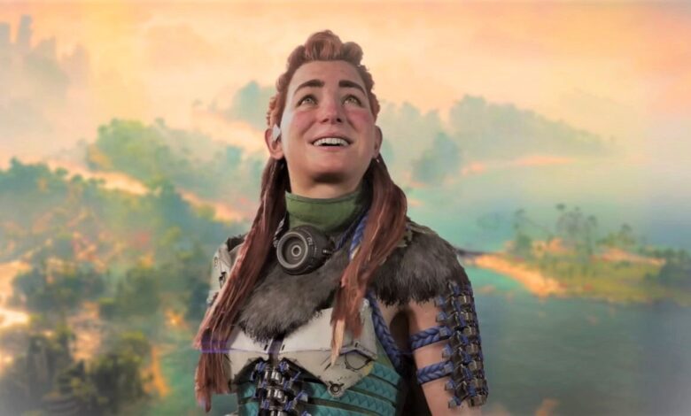 Aloy looking up at the sky and smiling against a landscape from Horizon Forbidden West Burning Shores.