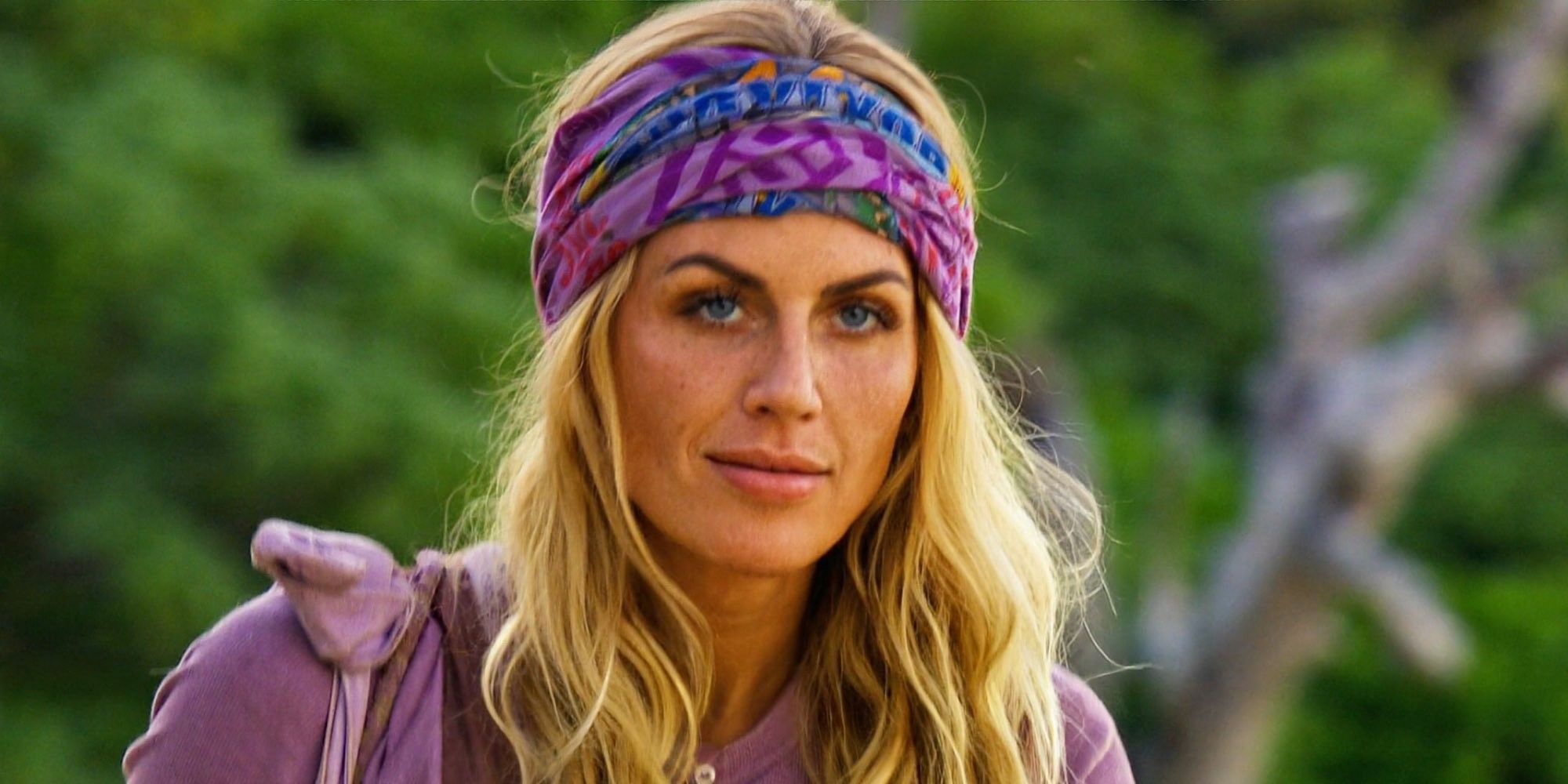 Carolyn Wiger from Survivor 44 dressed in purple looking pensive outside