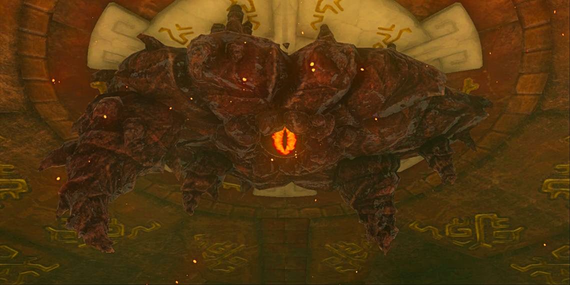 Marbled Gohma, a rocky, insectlike boss, hangs from the ceiling of Tears of the Kingdom's Fire Temple. In the center of its massive form is a glowing orange eye.
