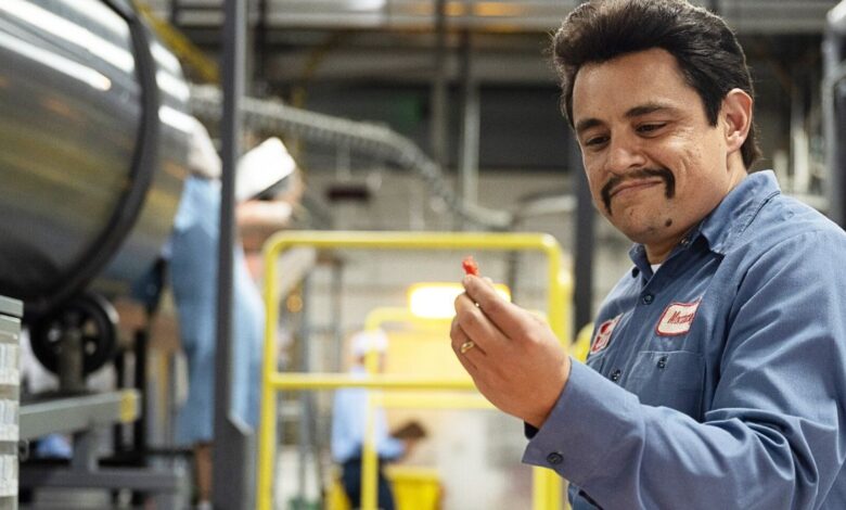 Jessie Garcia holding a cheeto and smiling in Flamin Hot