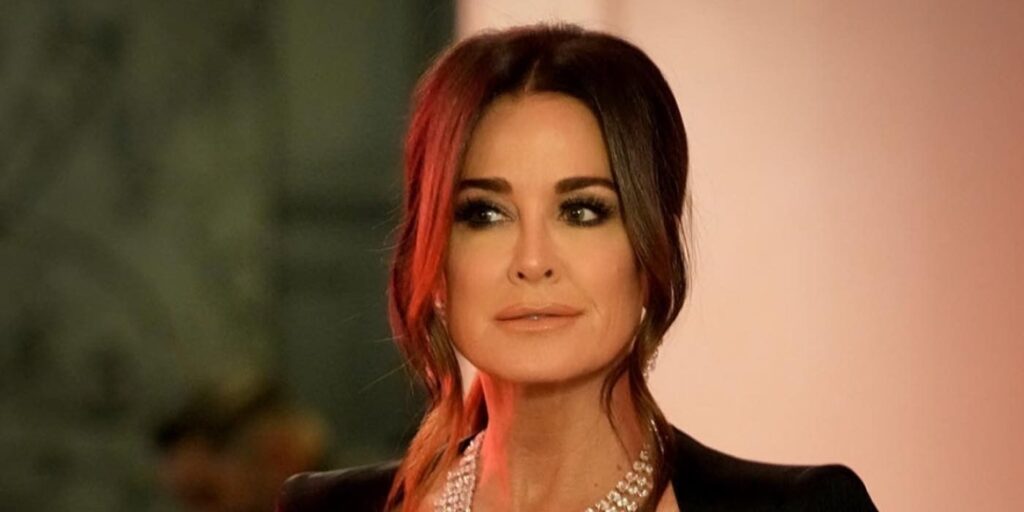 Kyle Richards smiling to someone off camera on RHOBH