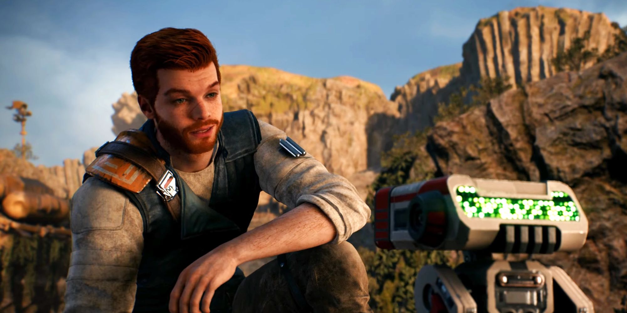 Cal Kestis on the left side of the image kneels down and talks to BD-1, who is in the foreground on the right side of the frame.