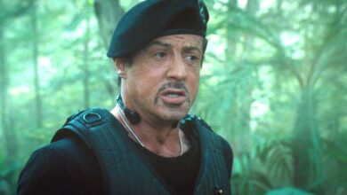 Sylvester Stallone in The Expendables wearing a flak jacket and beret in the jungle
