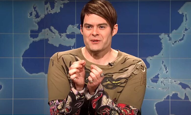 Bill Hader as Stefon on Saturday Night Live looking nervous against the backdrop of a world map