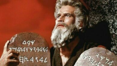 Charlton Heston as Moses holding the ten commandments in The Ten Commandments