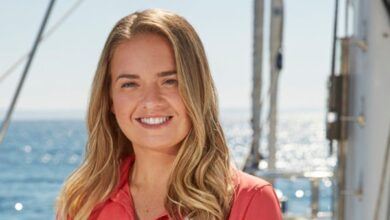 Below Deck Sailing Yacht's Daisy Kelliher smiling on a yacht