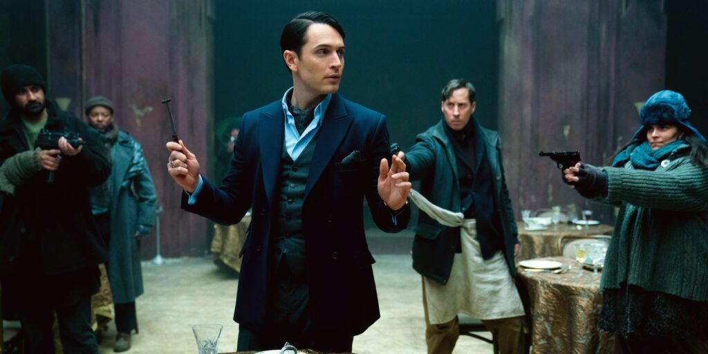 Colin Woodell as Winston with guns pointed at him in The Continental