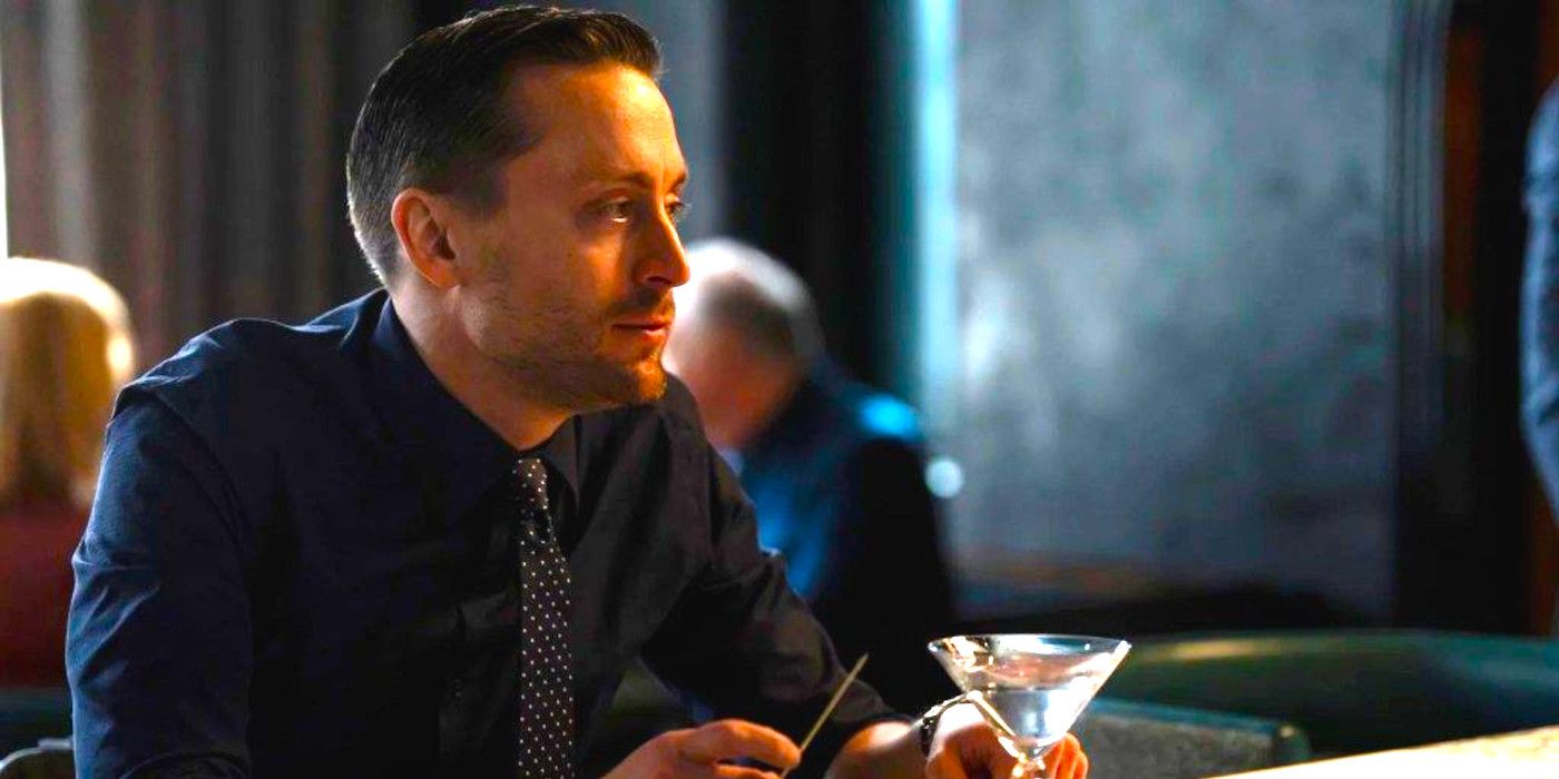 Kieran Culkin as Roman Roy in Succession sitting at a bar drinking a martini and looking vacant and sad