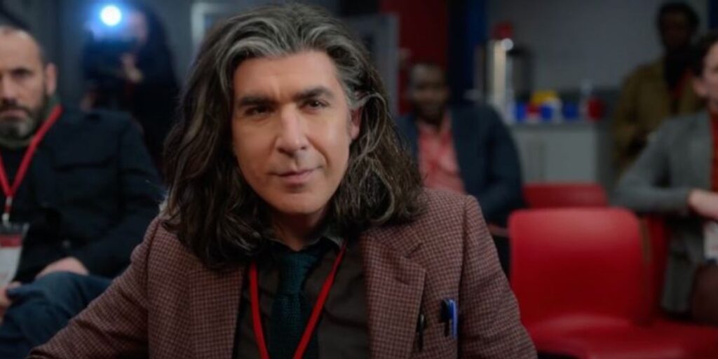 Trent Crimm smiling at a press conference in Ted Lasso