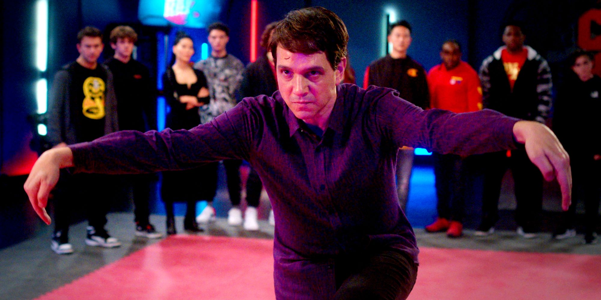 Ralph Macchio as Daniel LaRusso doing the crane kick in Cobra Kai season 5