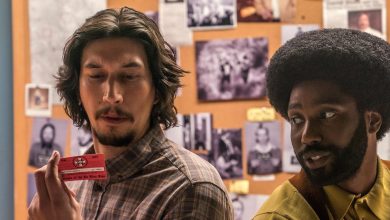 Flip and Ron looking at a card in BlacKkKlansman.