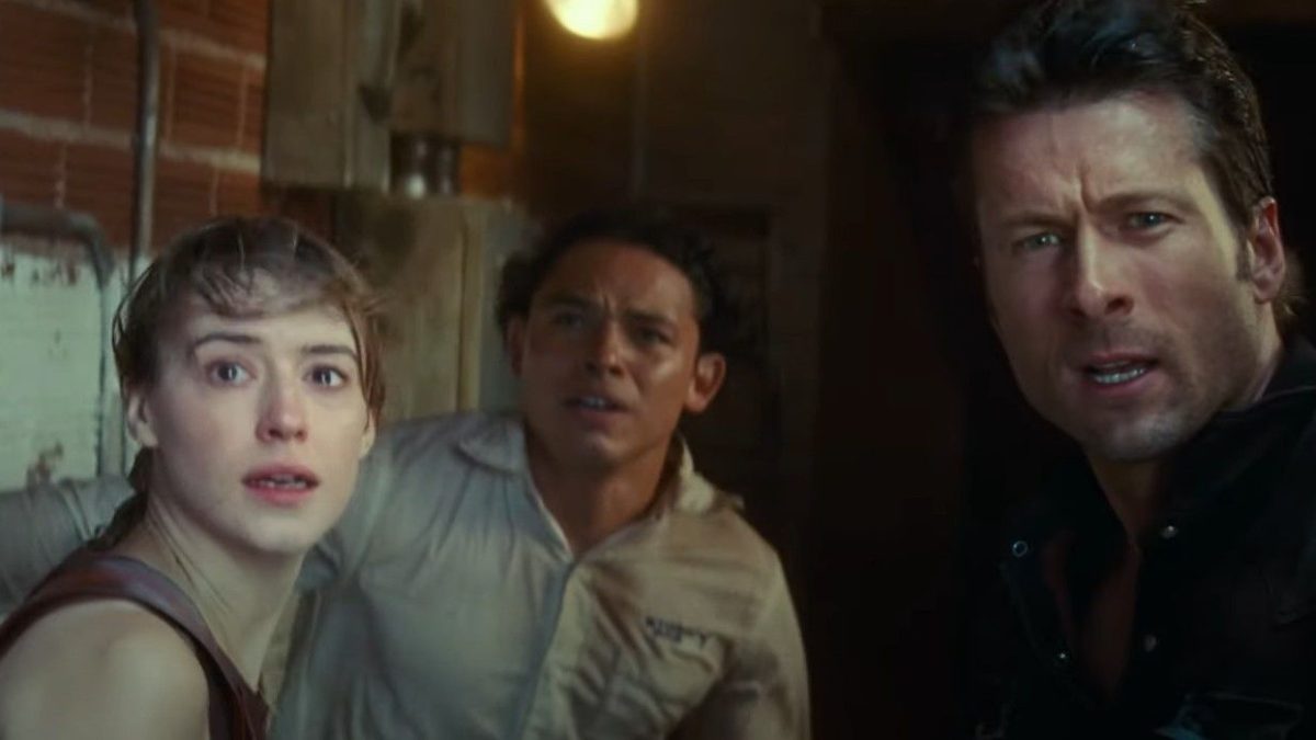 Daisy Edgar-Jones, Anthony Ramos, and Glen Powell looking in shock and awe at a storm in Twisters
