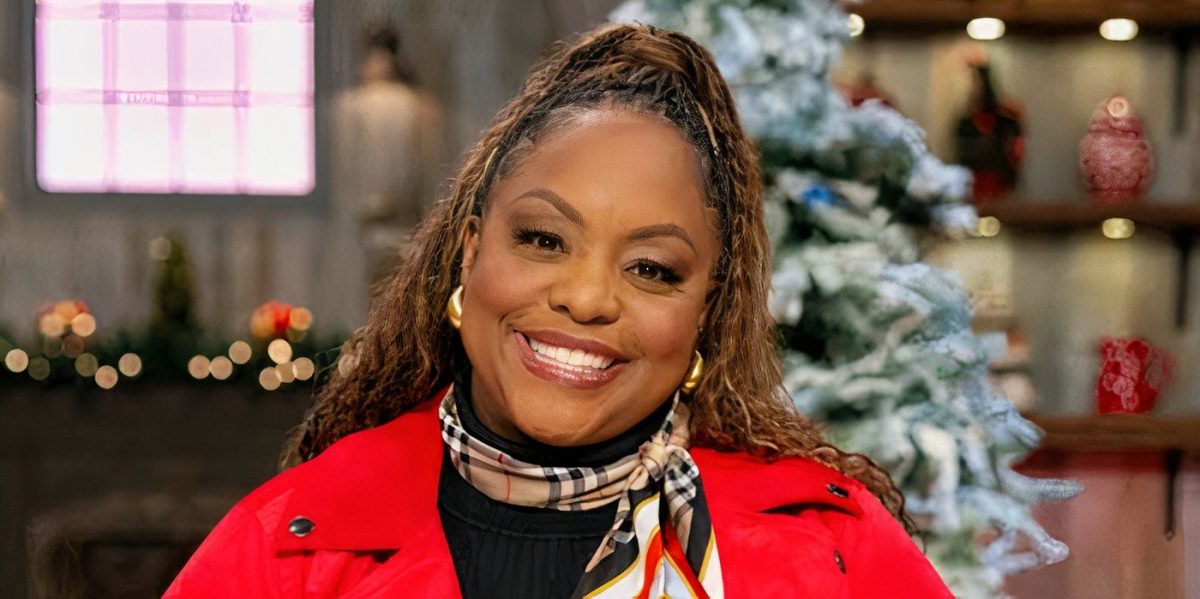 Kardea Brown Smiling In Front Of A Christmas Tree