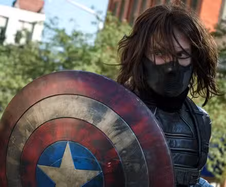 Bucky Barnes de Sebastian Stan sostiene el escudo de Steve Rogers en Capitán América El Soldado de Invierno