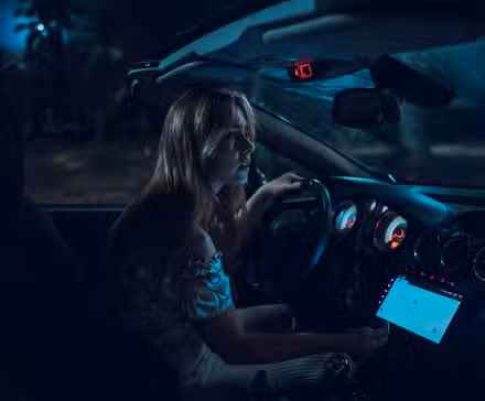 Mujer rubia dentro de un auto en la jungla de noche en That Night de Netflix