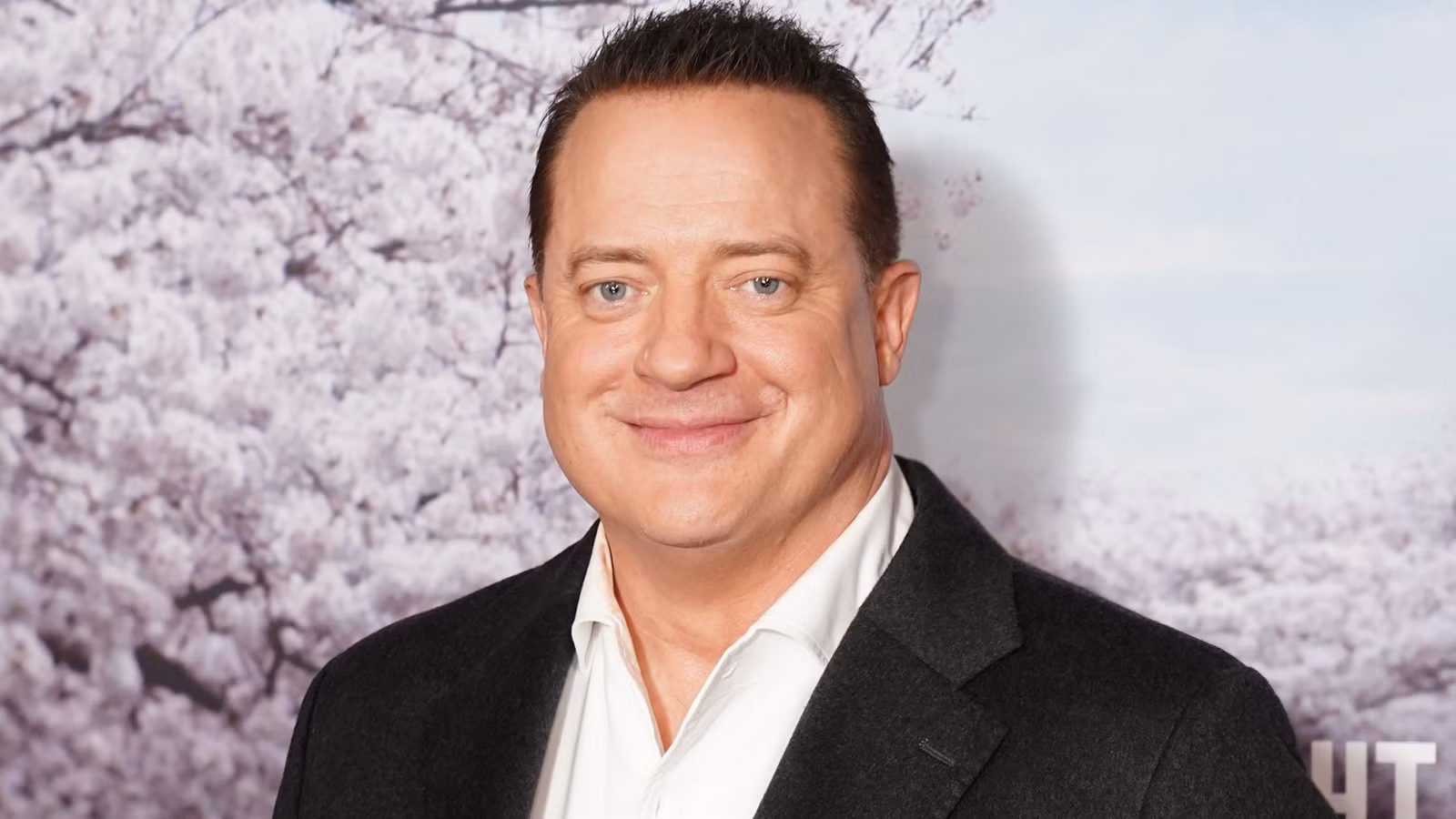 Brendan Fraser sonriendo en la alfombra roja de Rental Family