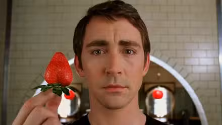 Ned, interpretado por Lee Pace, sostiene una fresa en Pushing Daisies.