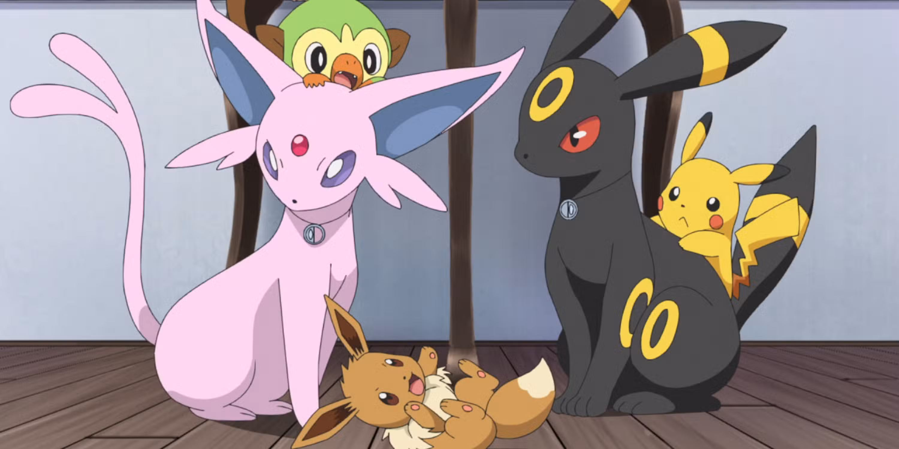 Captura de pantalla de Pokémon de Espeon y Umbreon con otros Pokémon jugando a su alrededor