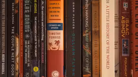 Libros de bolsillo de ciencia ficción y suspense mezclados en un estante
